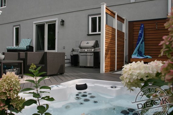 hot tub built into a low maintenance deck with privacy screens