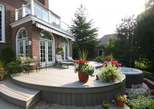 Image of a custom curved Trex deck with a built in circular hot tub. Crafted by Your Deck Company in Markham