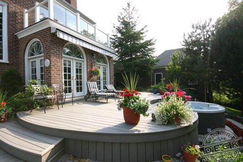 Image of a custom curved Trex deck with a built in circular hot tub. Crafted by Your Deck Company in Markham