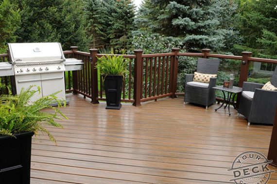 Image of a Trex deck constructed using Trex spiced rum decking. Your Deck Company is a deck builder in Aurora