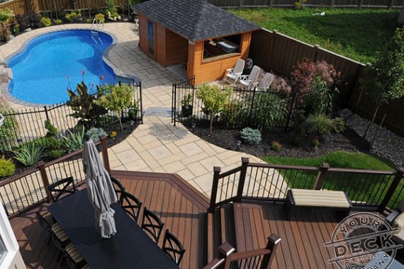 Backyard landscaping and a Trex deck overlooking the pool